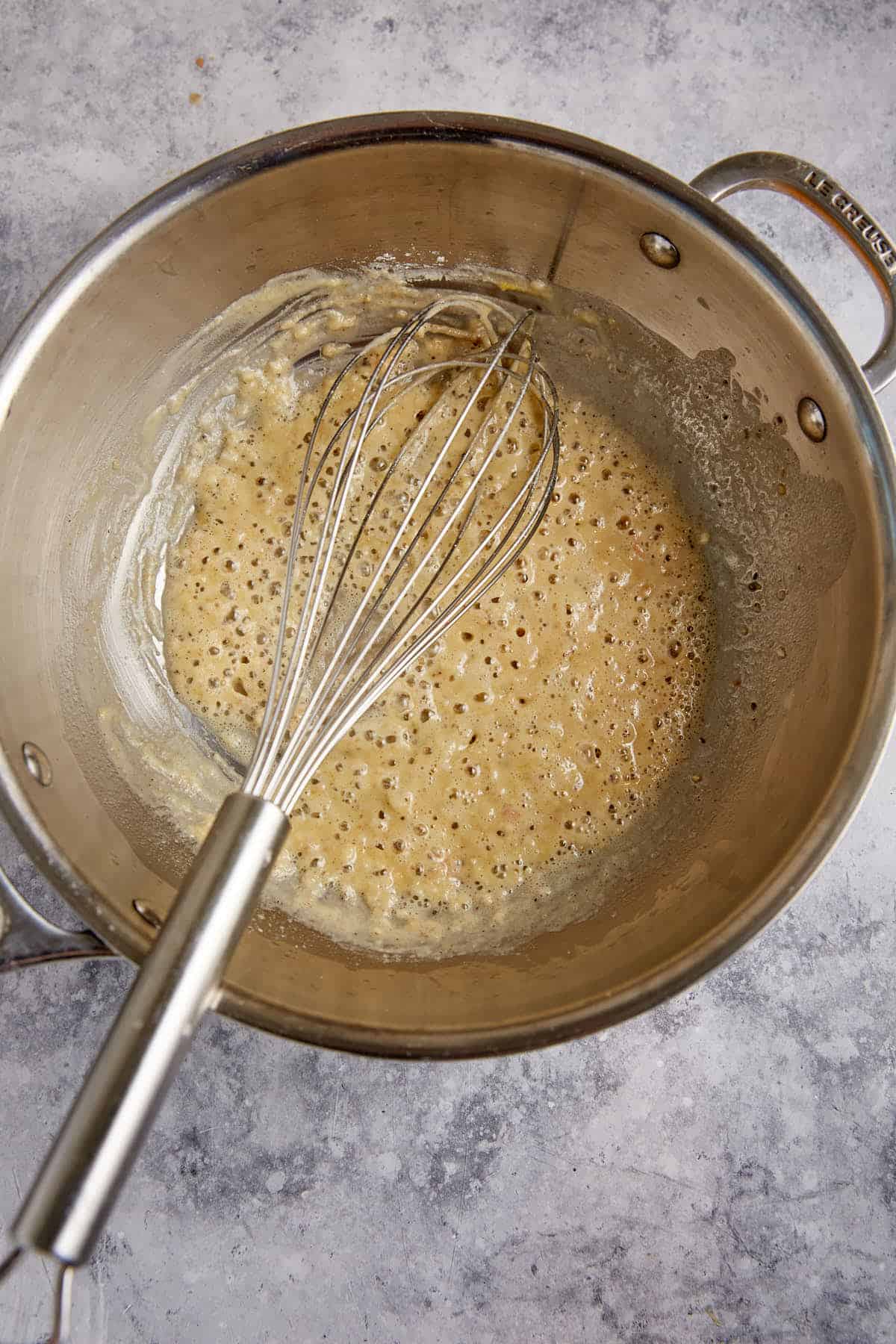A roux cooking in a saucepan.