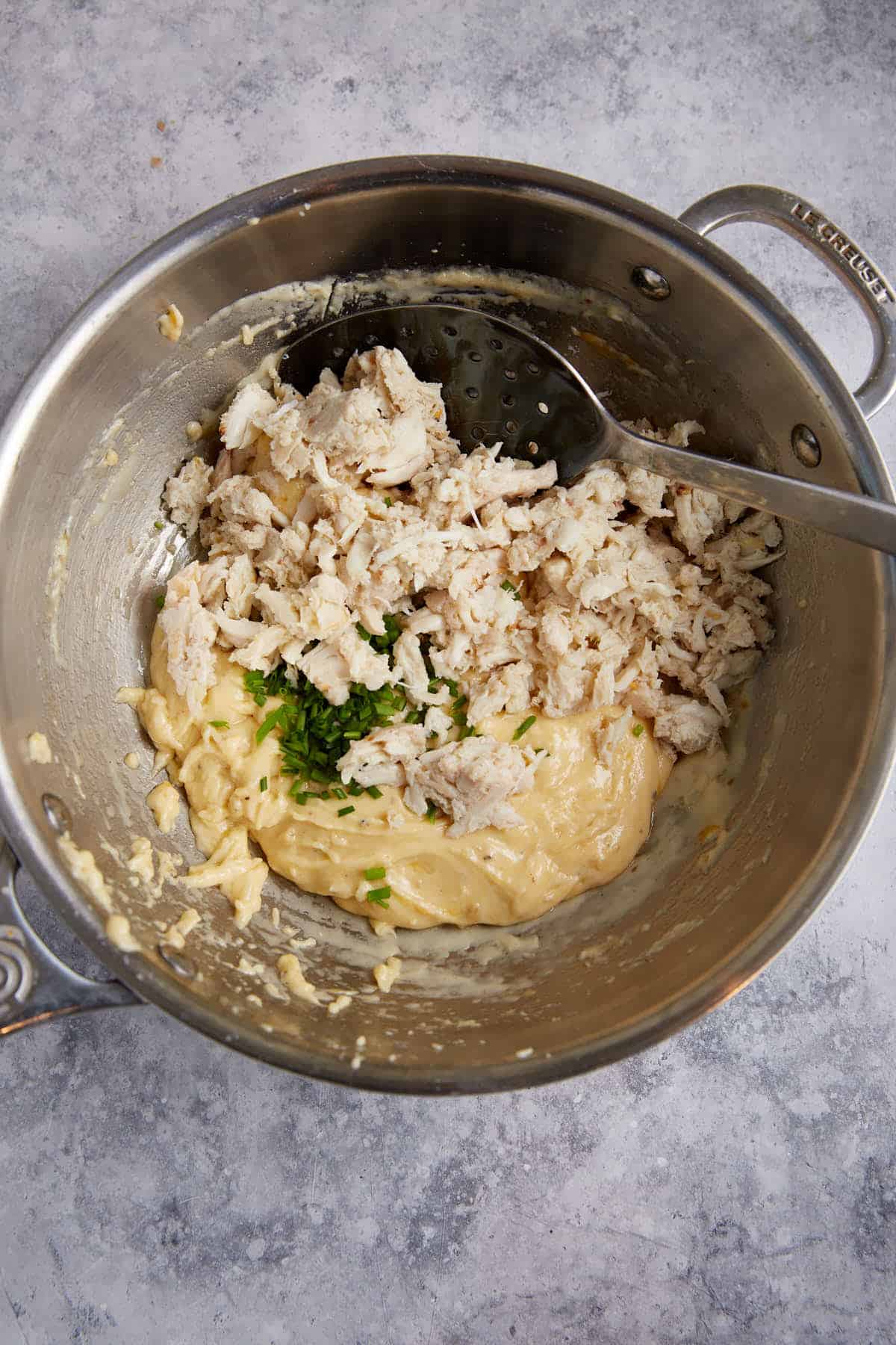 Crab being added to the dip.