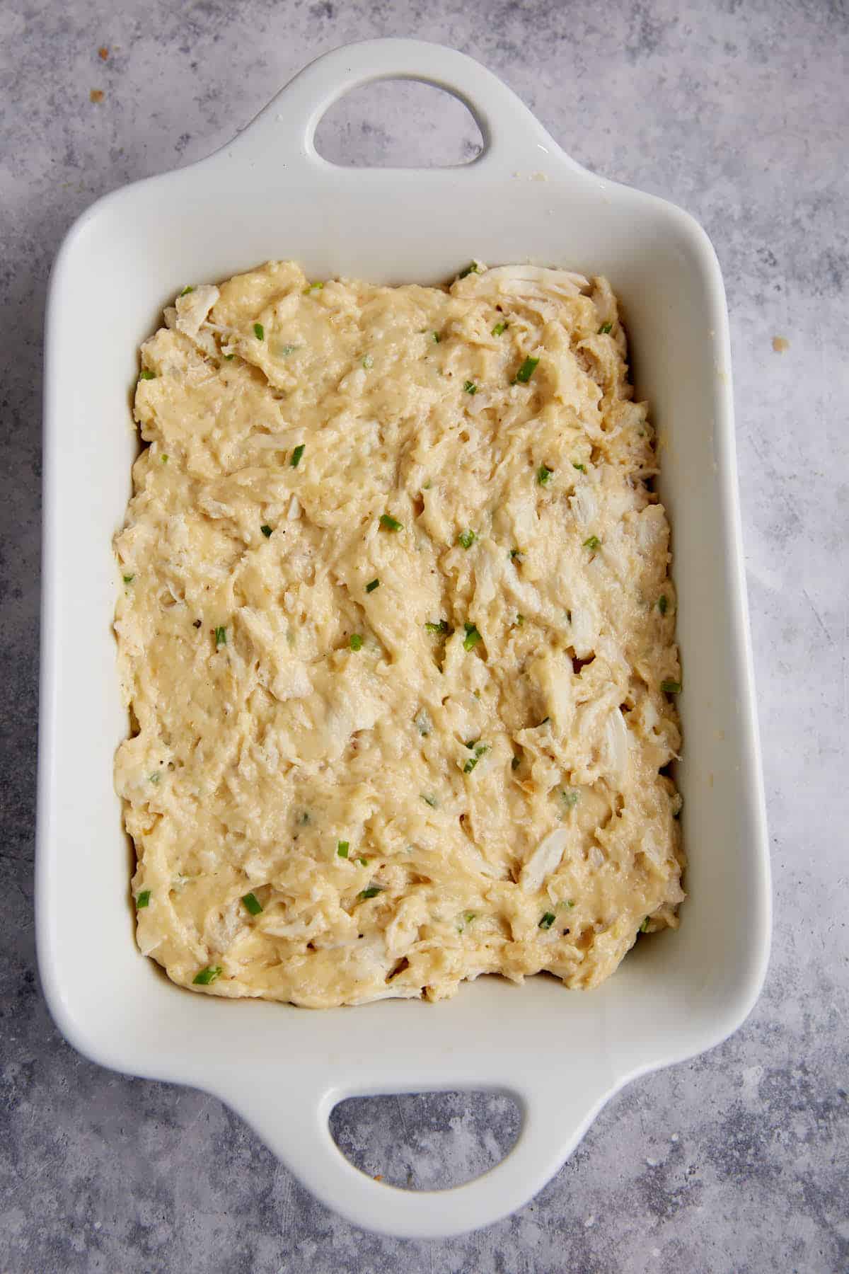 Crab dip spread in a baking dish.