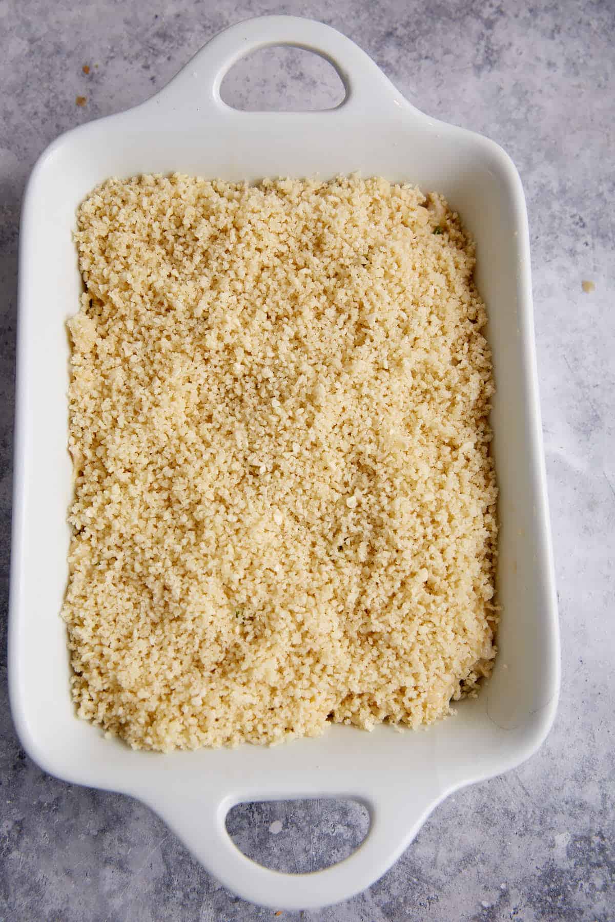 Crab dip sprinkled with panko and butter.