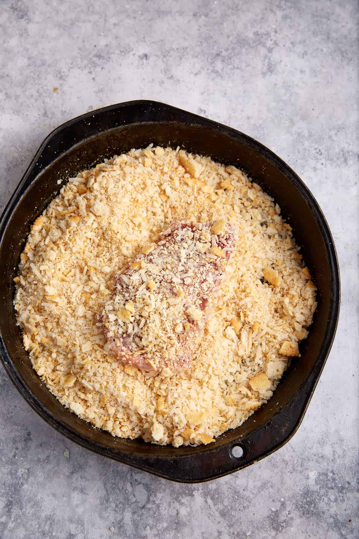 A pork cutlet coated in cracker crumbs.