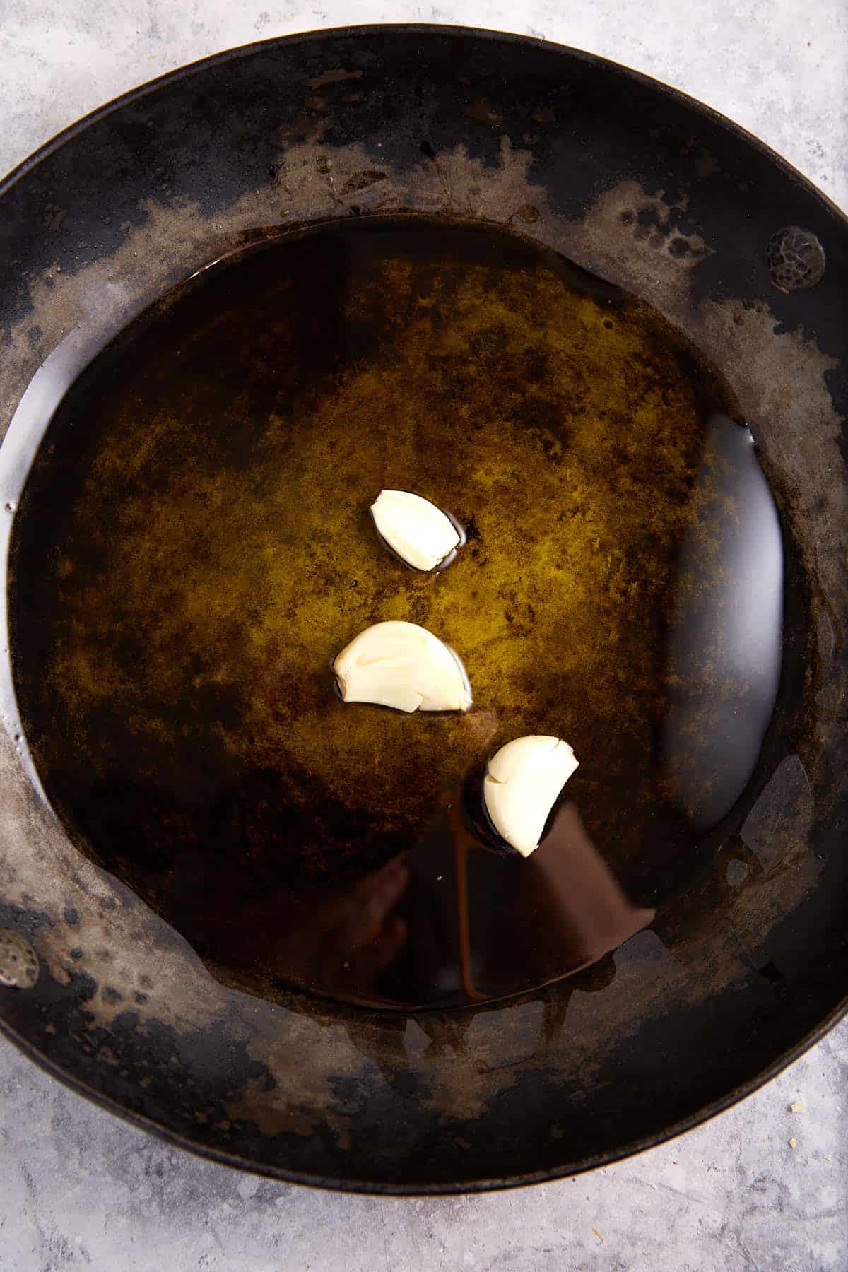 Garlic in oil in a skillet.