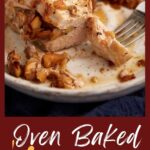 A plate of pork chops with apples with a fork.