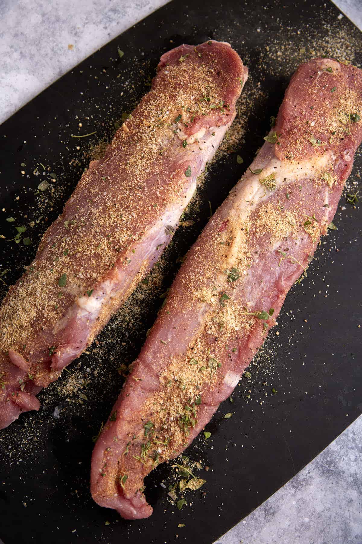 A dry rub on two pork tenderloins.