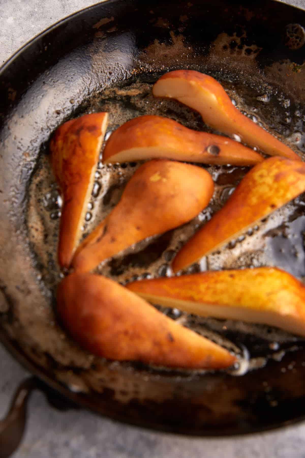 Pears cooking in a skillet.