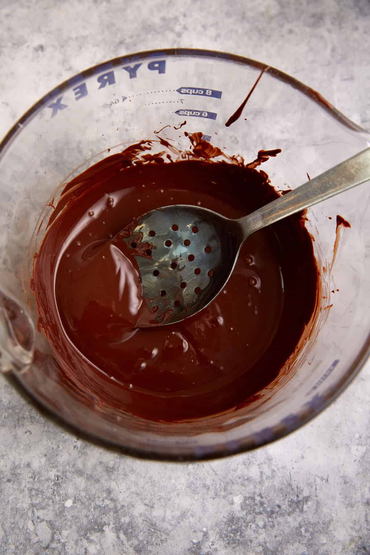 Chocolate melted in a measuring cup.