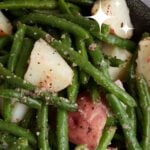 A plate of cold green bean salad with new potatoes.
