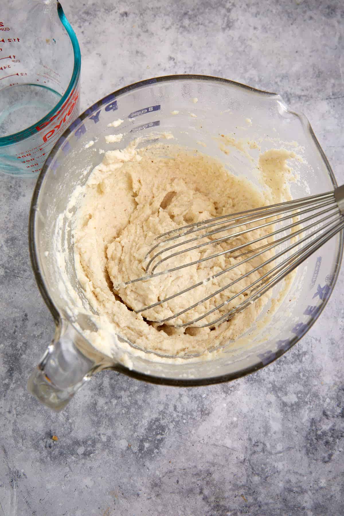 Dry ingredients with cream and oil in a mixing bowl.