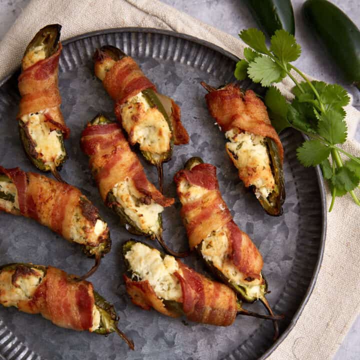 A plate of bacon wrapped jalapeno chicken poppers.