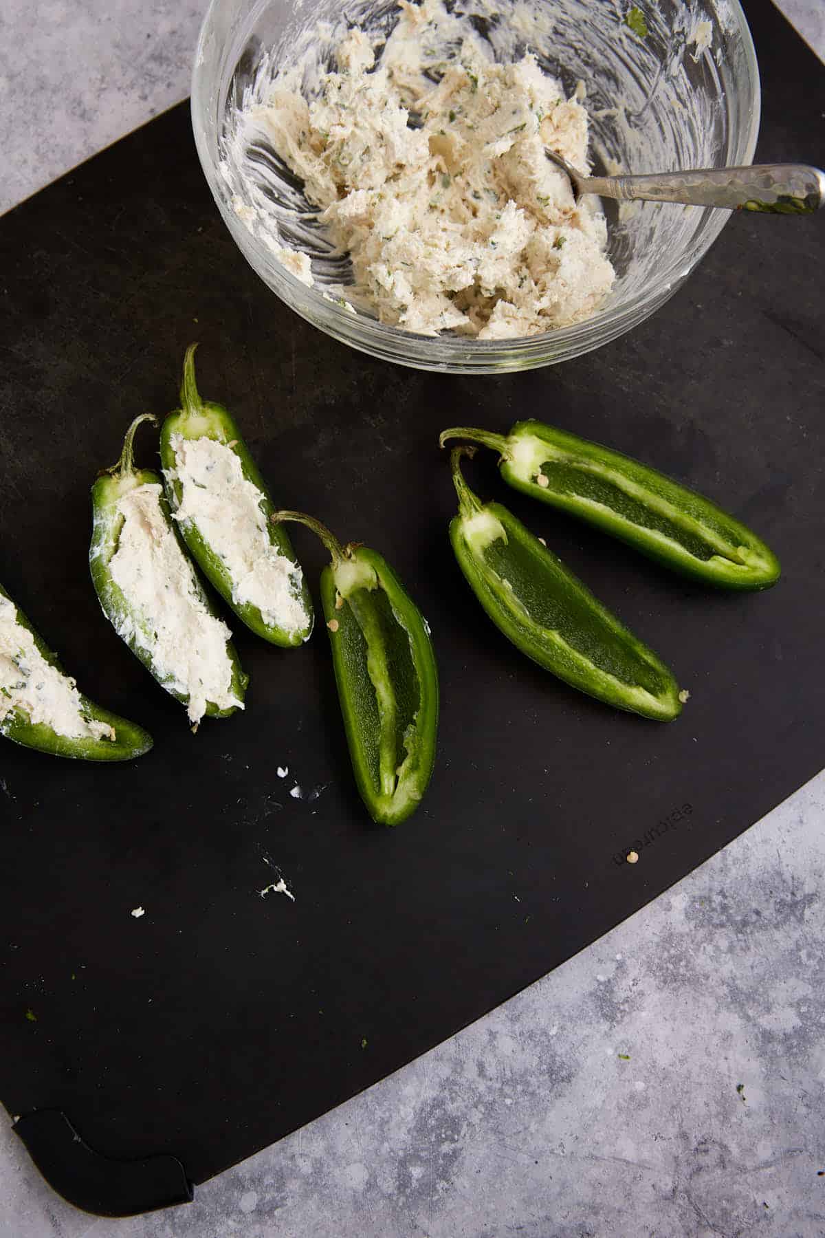 Jalapeno pepper halfs stuffed with filling.