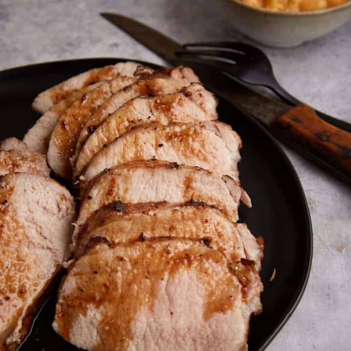 A platter with slices of a pork loin.