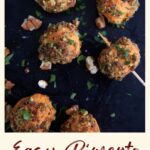 Cream Cheese Balls coated in bacon on a tray.