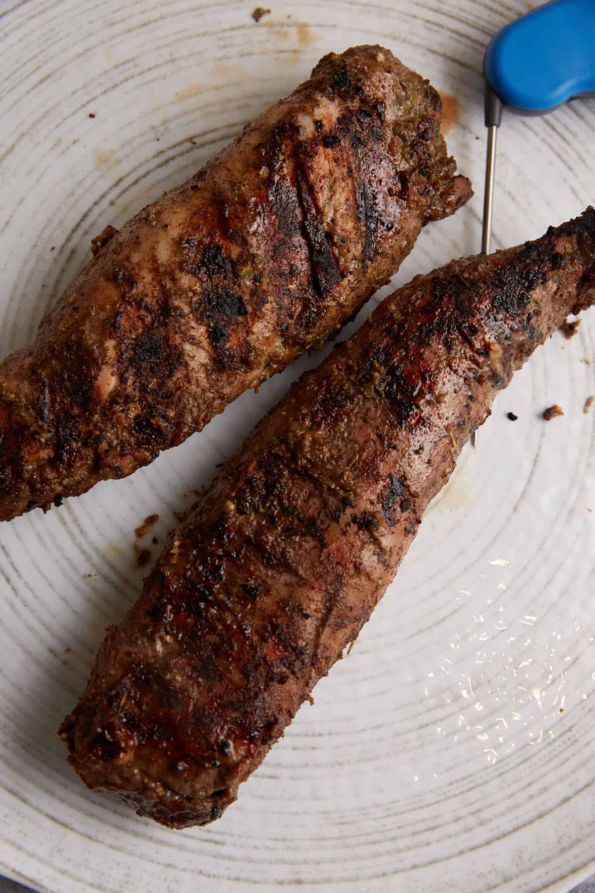 Two grilled pork tenderloins on a plate.