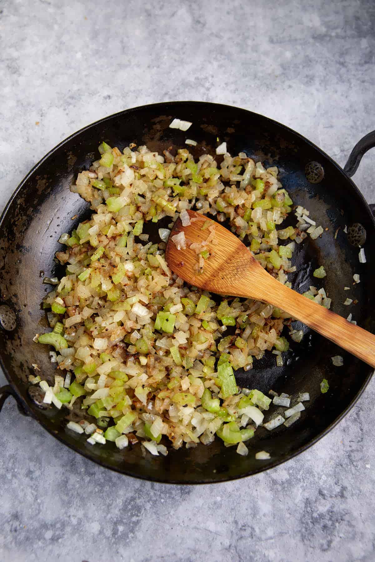 Sauted onions and celery in a skillet.