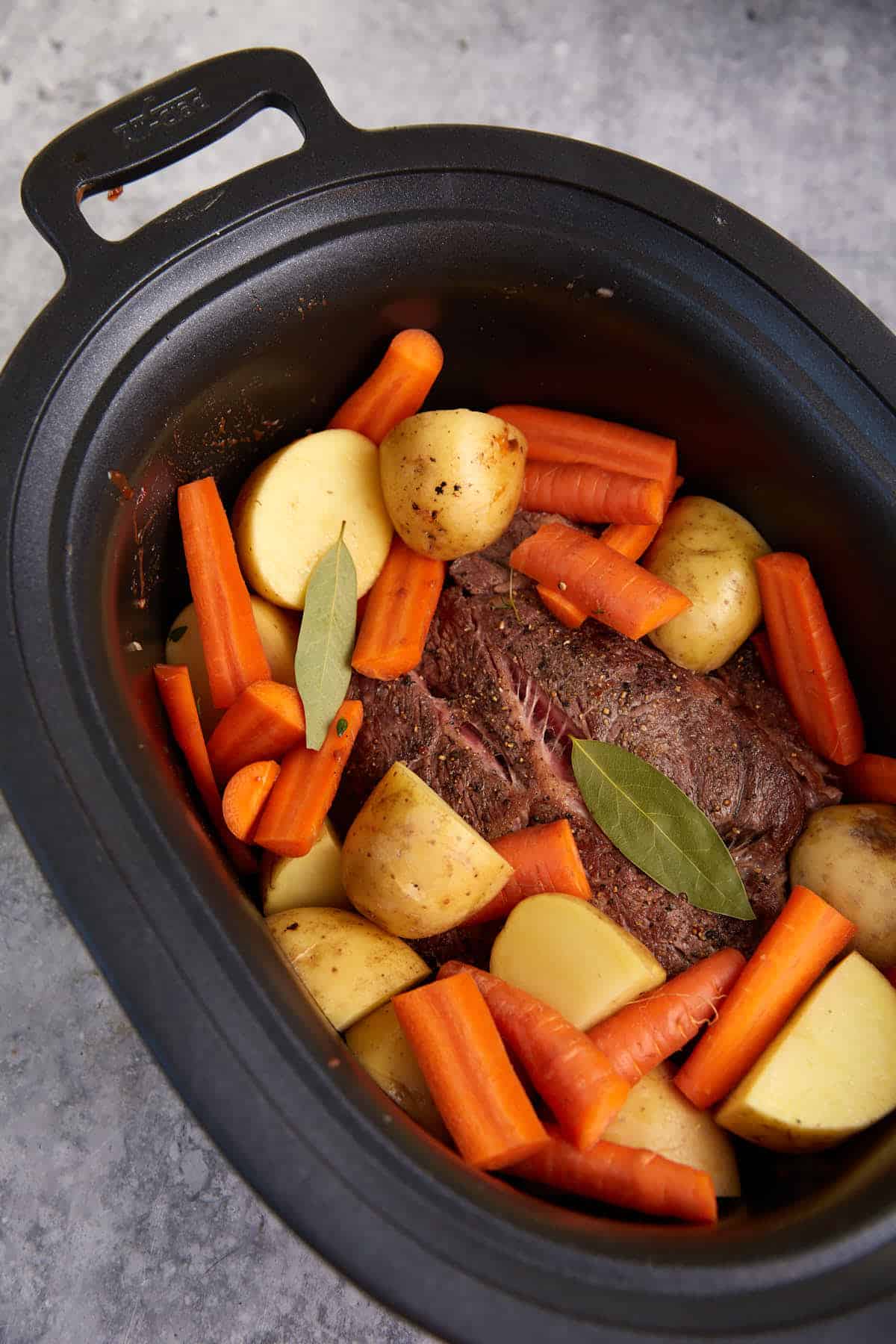 Meat and veggies in a slow cooker. 