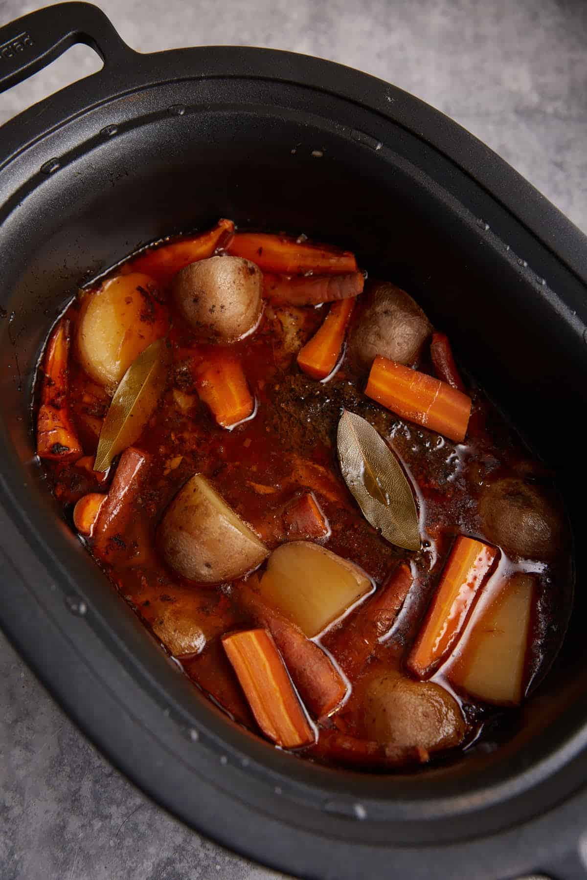 Cooked pot roast in a slow cooker. 