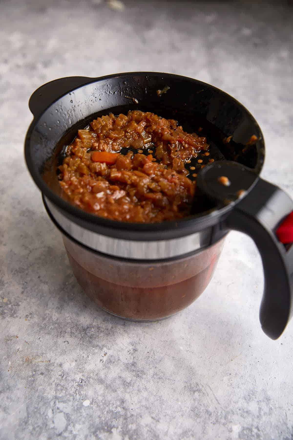 A fat separator with juice in it. 