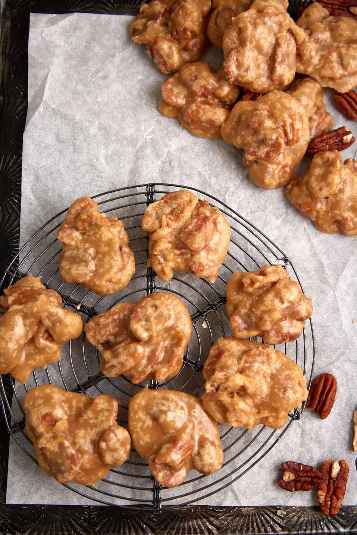 Pecan pralines on a cooling rack.