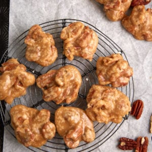 Pecan pralines on a wire rack.