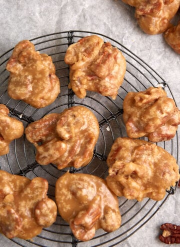 Pecan pralines on a wire rack.