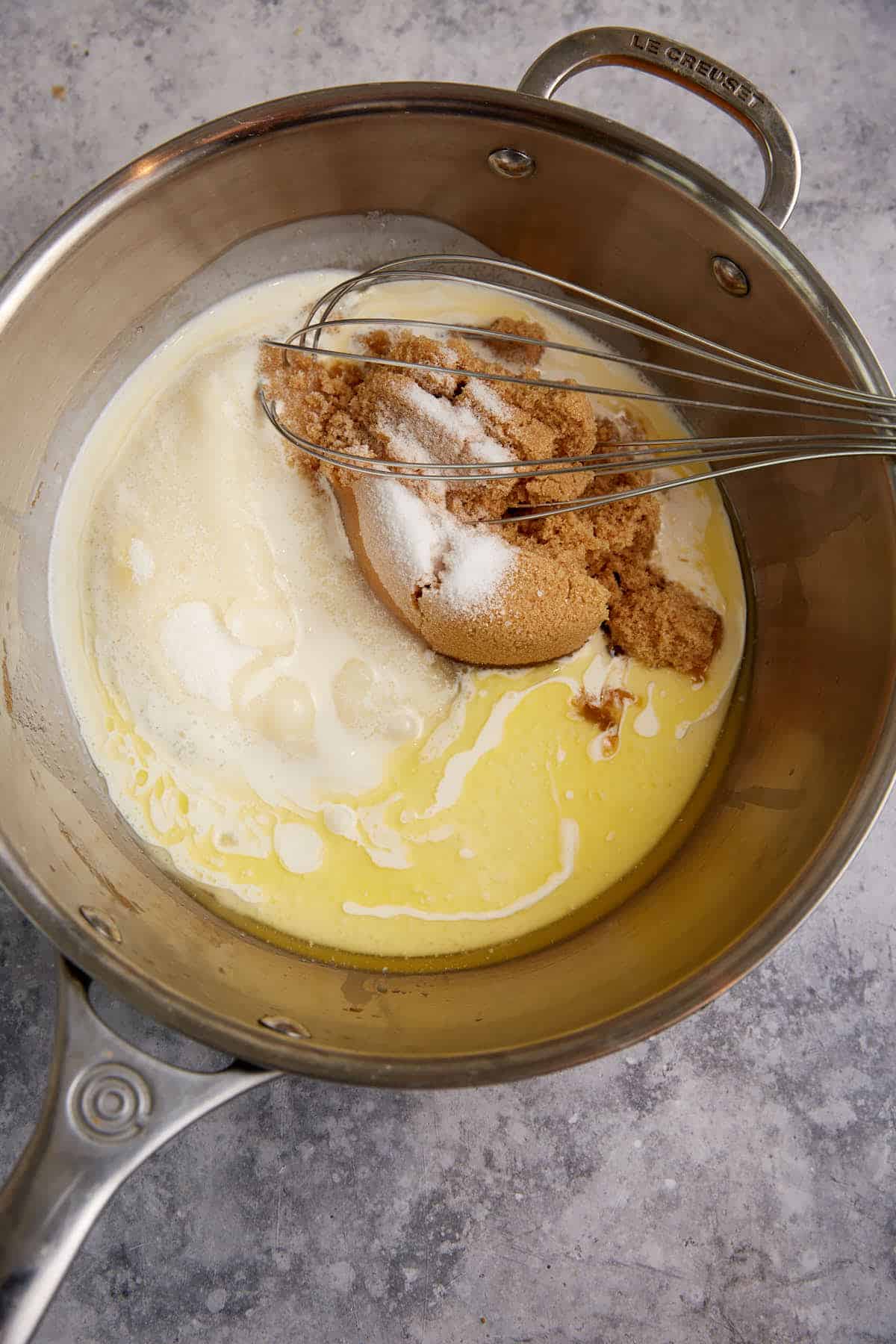 A saucepan with sugar and butter and cream.