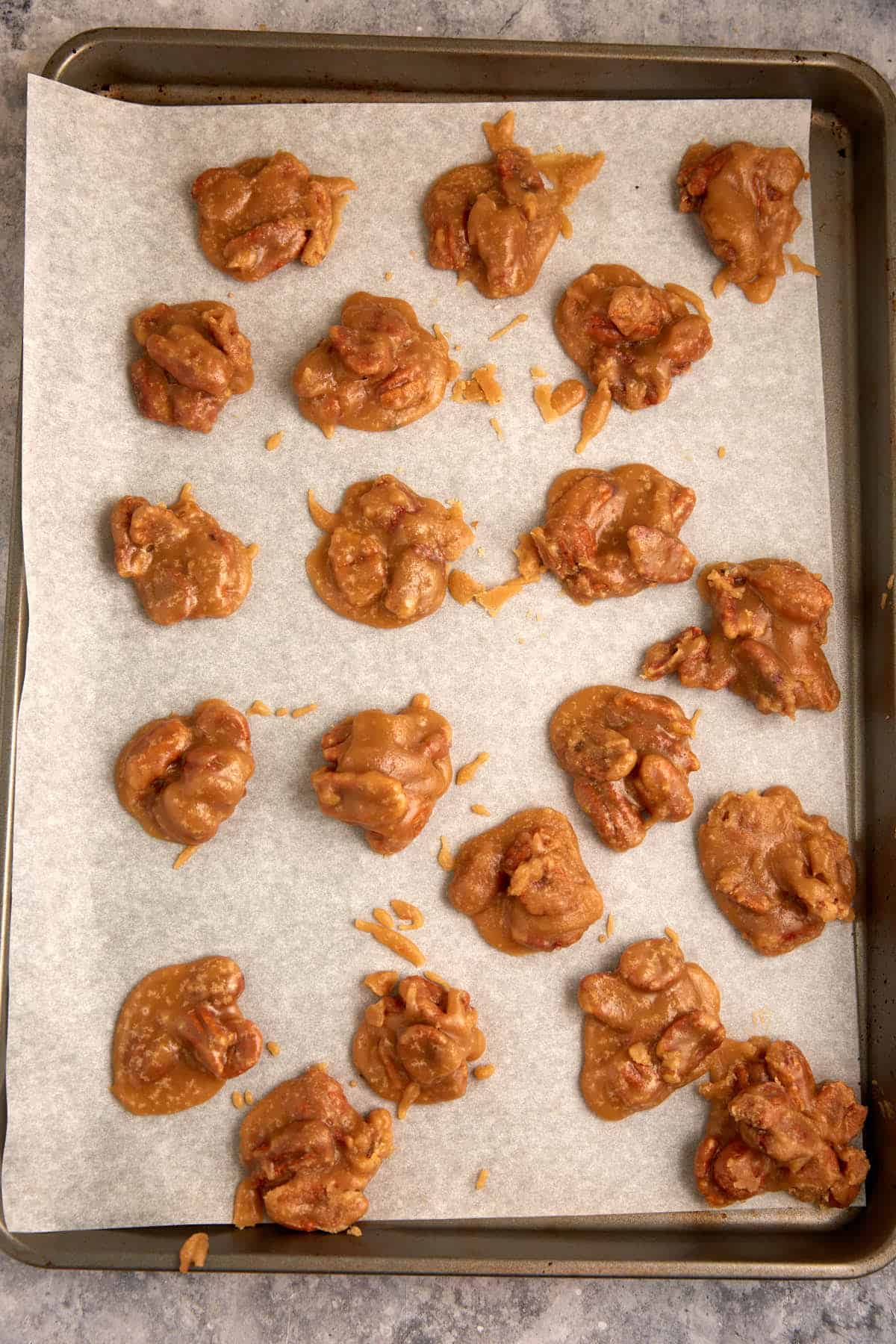 Pralines scooped onto a baking sheet.