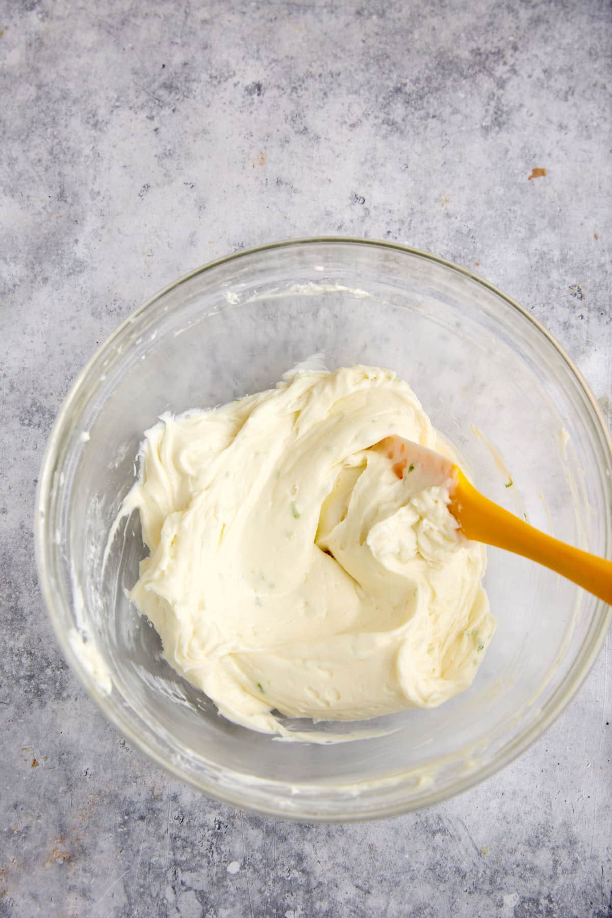 A bowl of cream cheese filling for raspberry tarts.