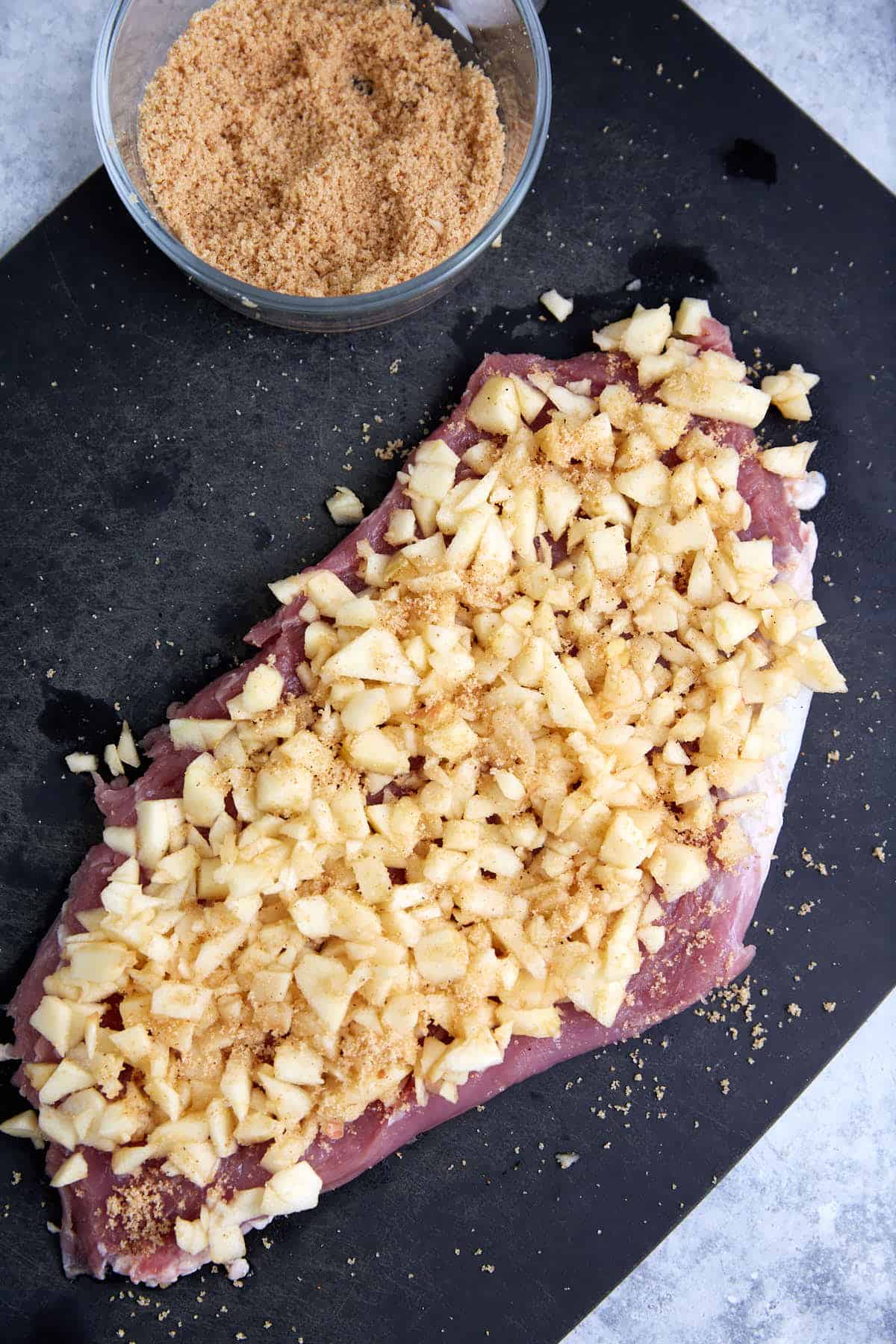 Chopped apples on the top of a tenderloin.