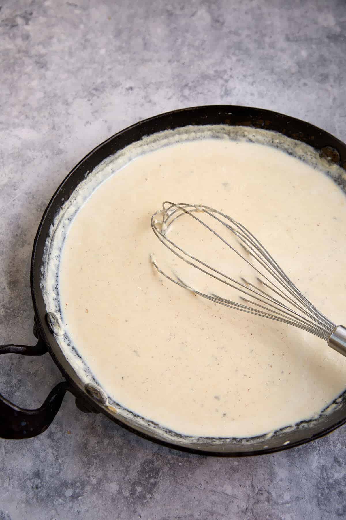 A white sauce in a skillet.