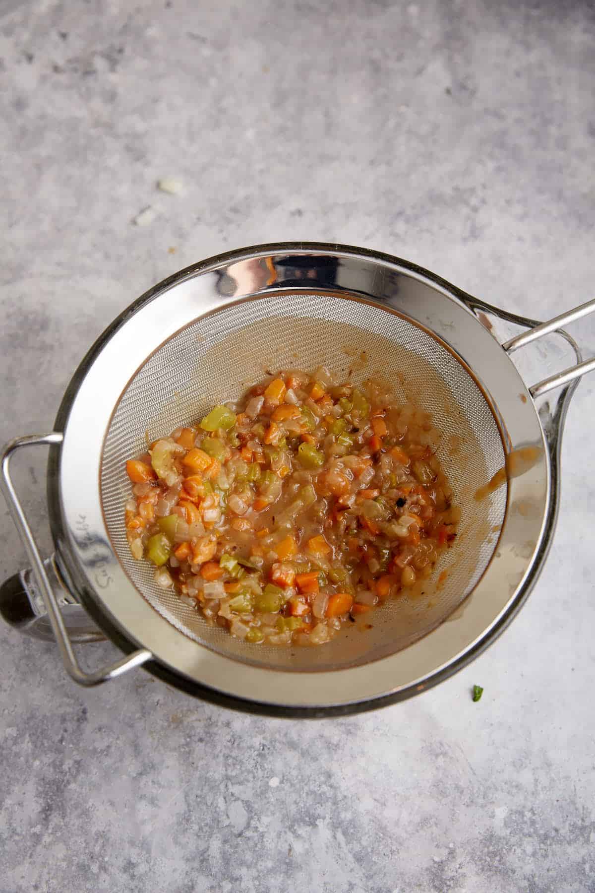 Gravy poured through a strainer.