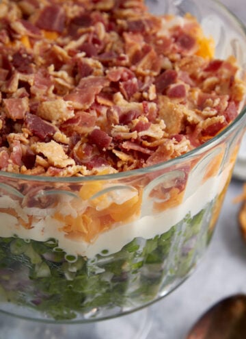 A glass bowl of 7 layer salad.