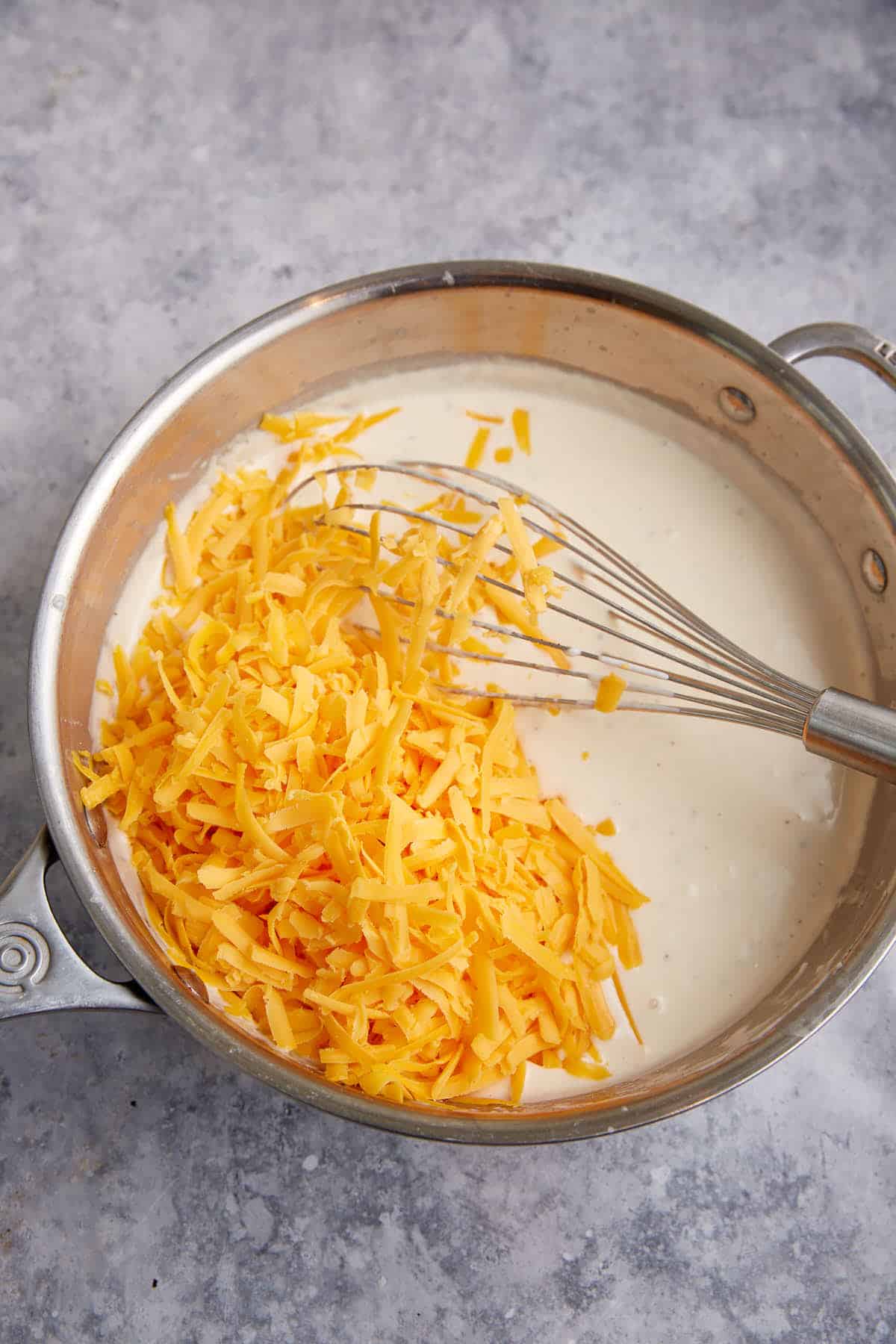 Cheese in a saucepan with ranch sauce.