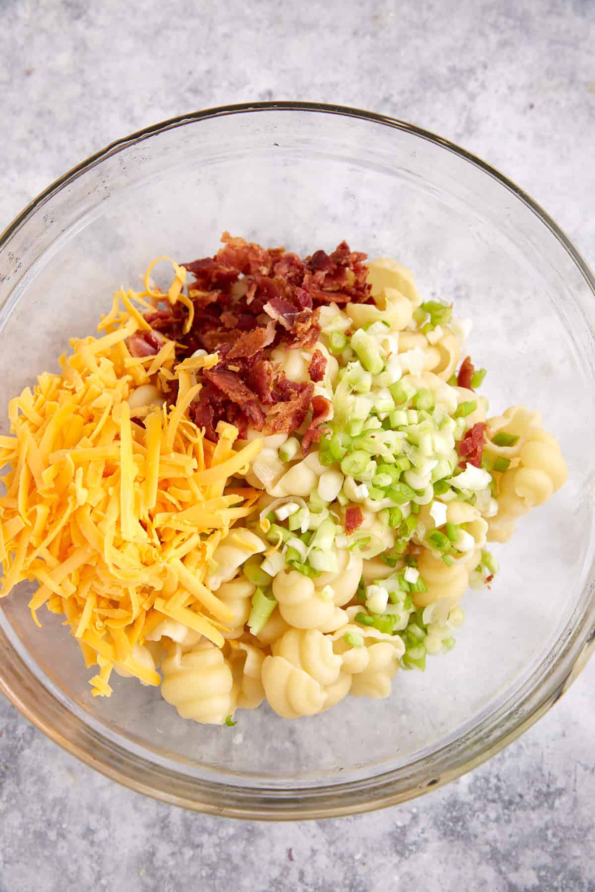 Cheese, bacon and onions added to cooked pasta.