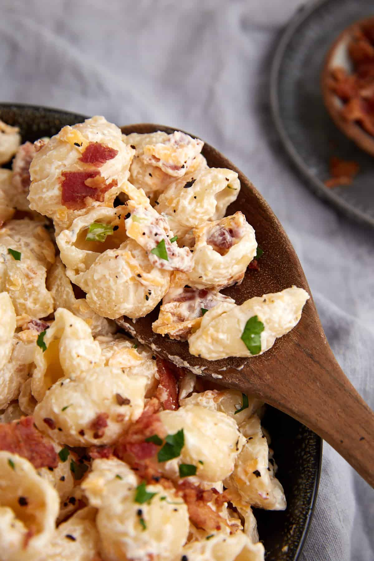 A spoon full of bacon ranch pasta salad.