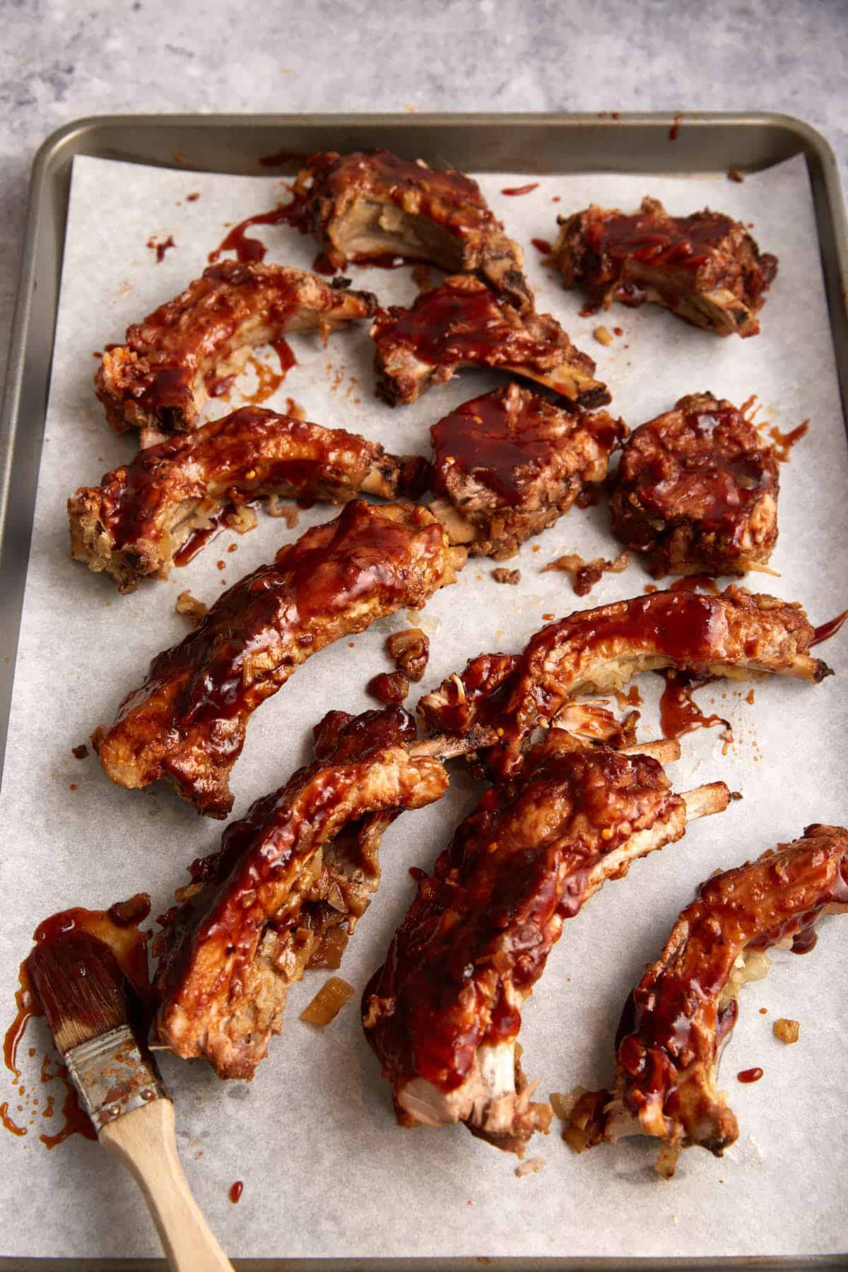 Individual pork ribs on parchment paper.