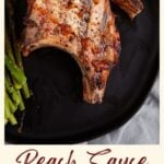 BBQ pork chops with peach sauce on a plate with asparagus.