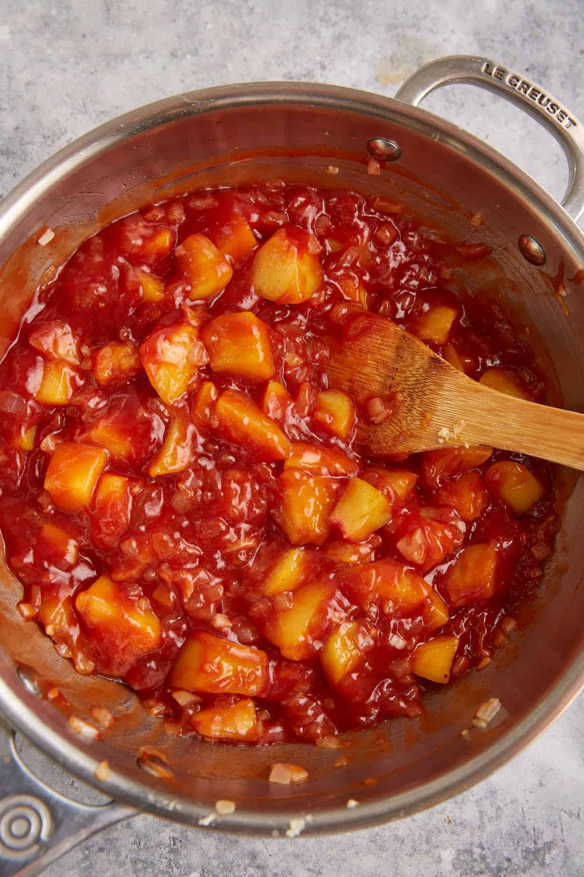Peaches cooking in a saucepan.