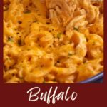 A spoon pulling out a serving of mac and cheese with buffalo sauce.