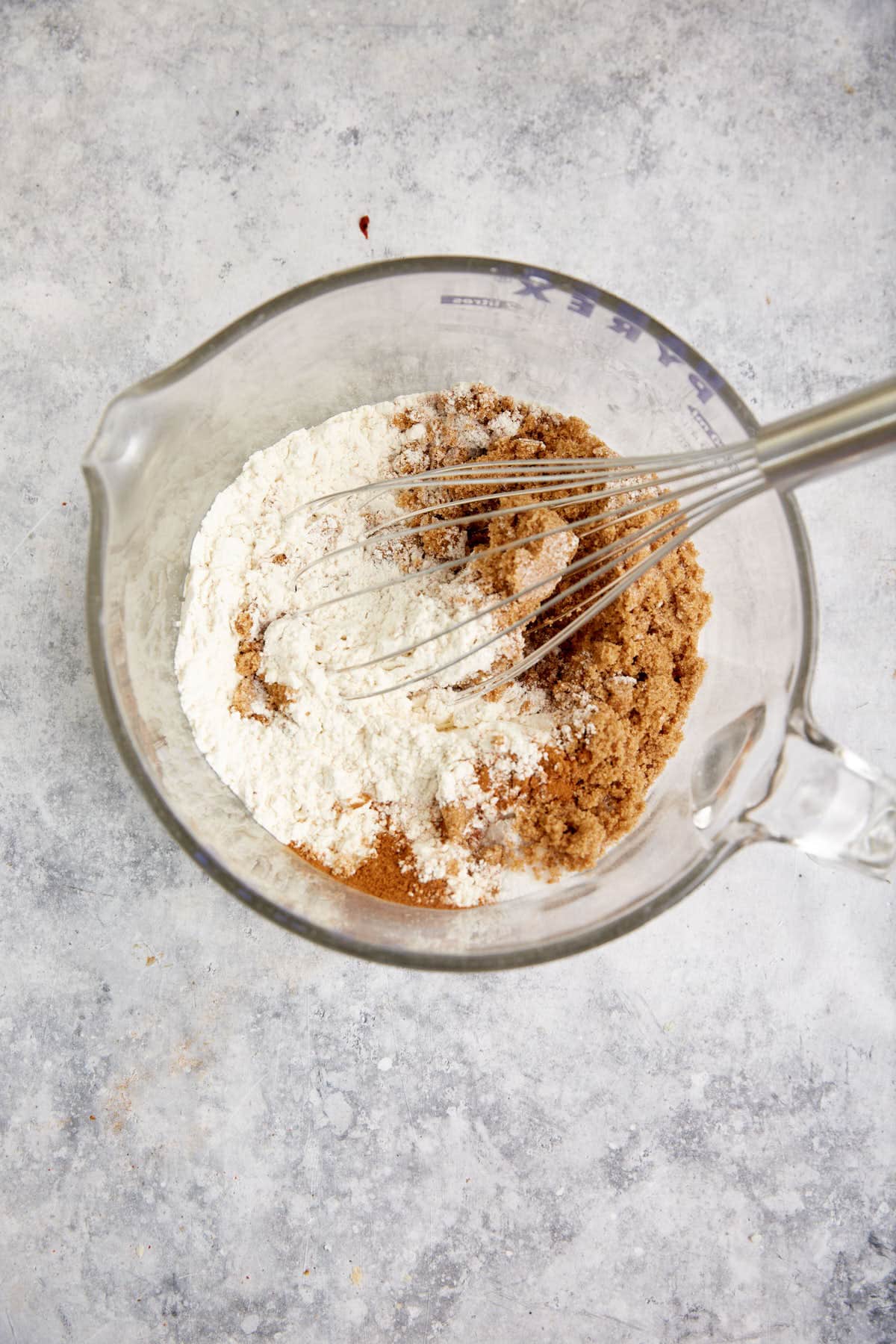 The dry ingredients with a whisk in a mixing bowl.