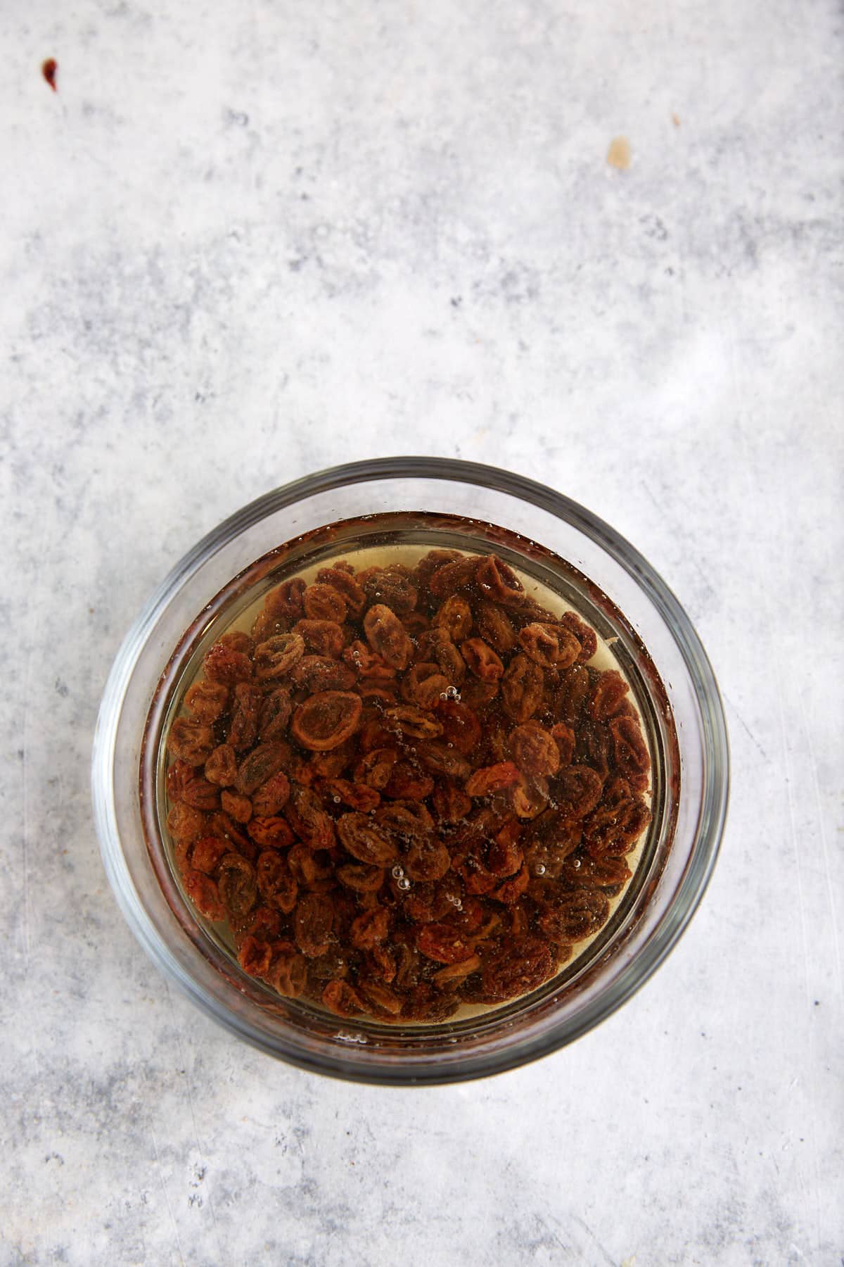 Raisins in a bowl of hot water.