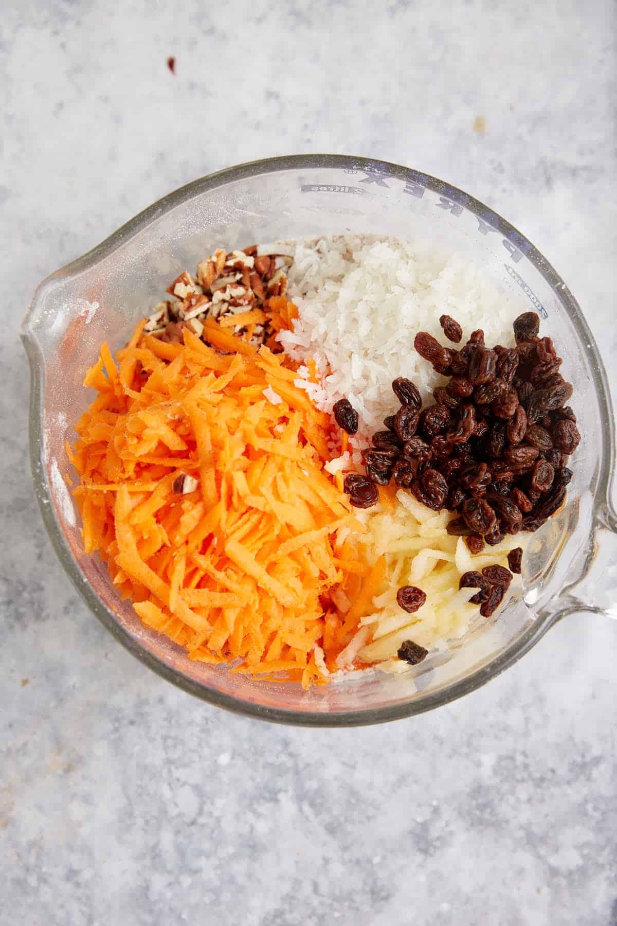 A bowl of shredded ingredients for morning glory muffins.
