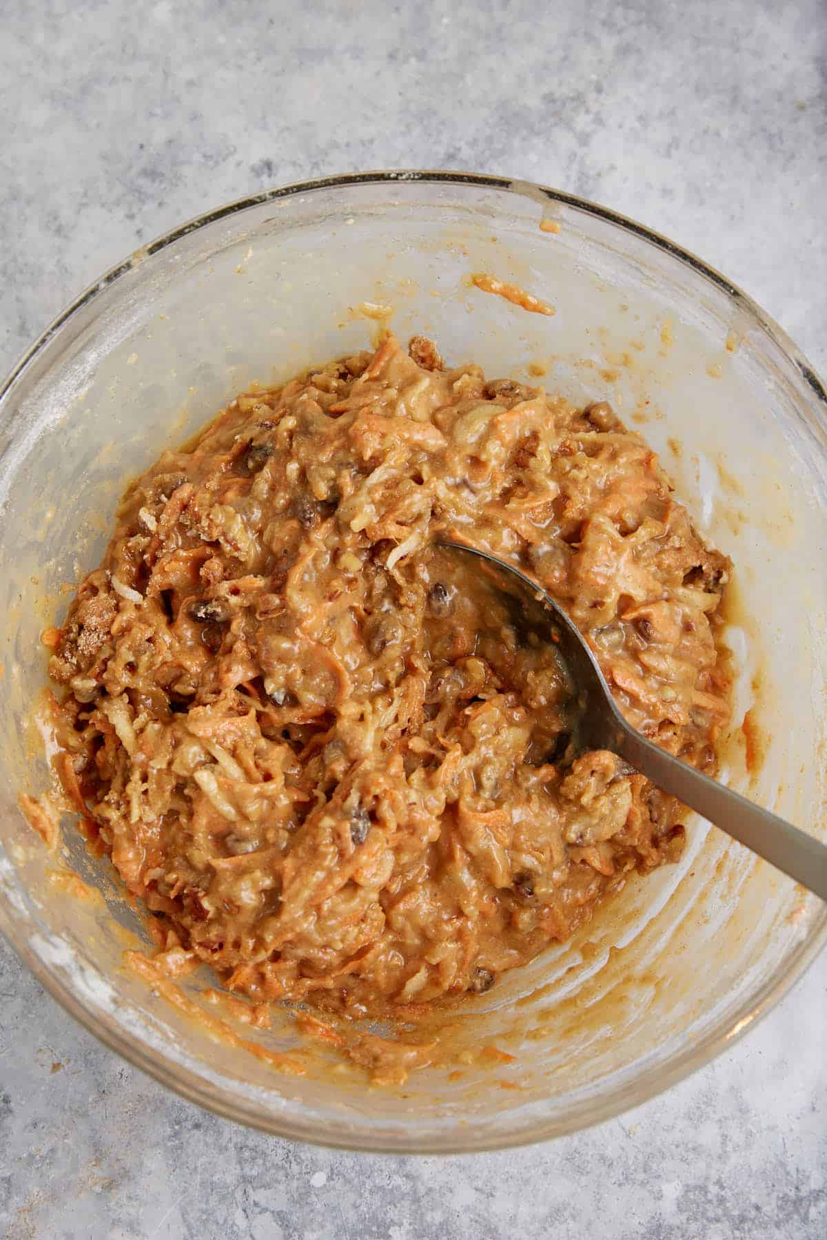 The batter for morning glory muffins in a bowl.