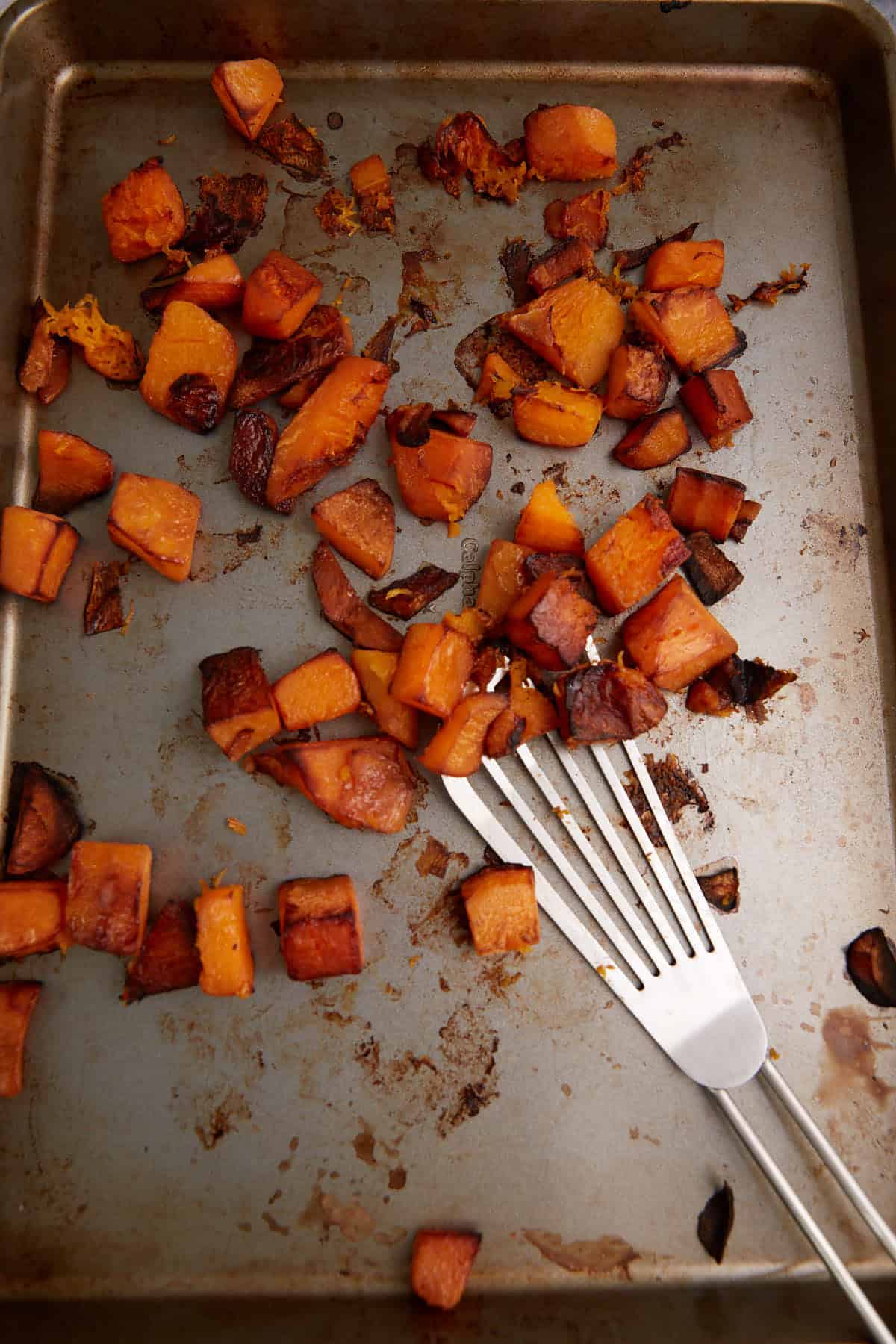 Roasted butternut squash on a baking sheet.