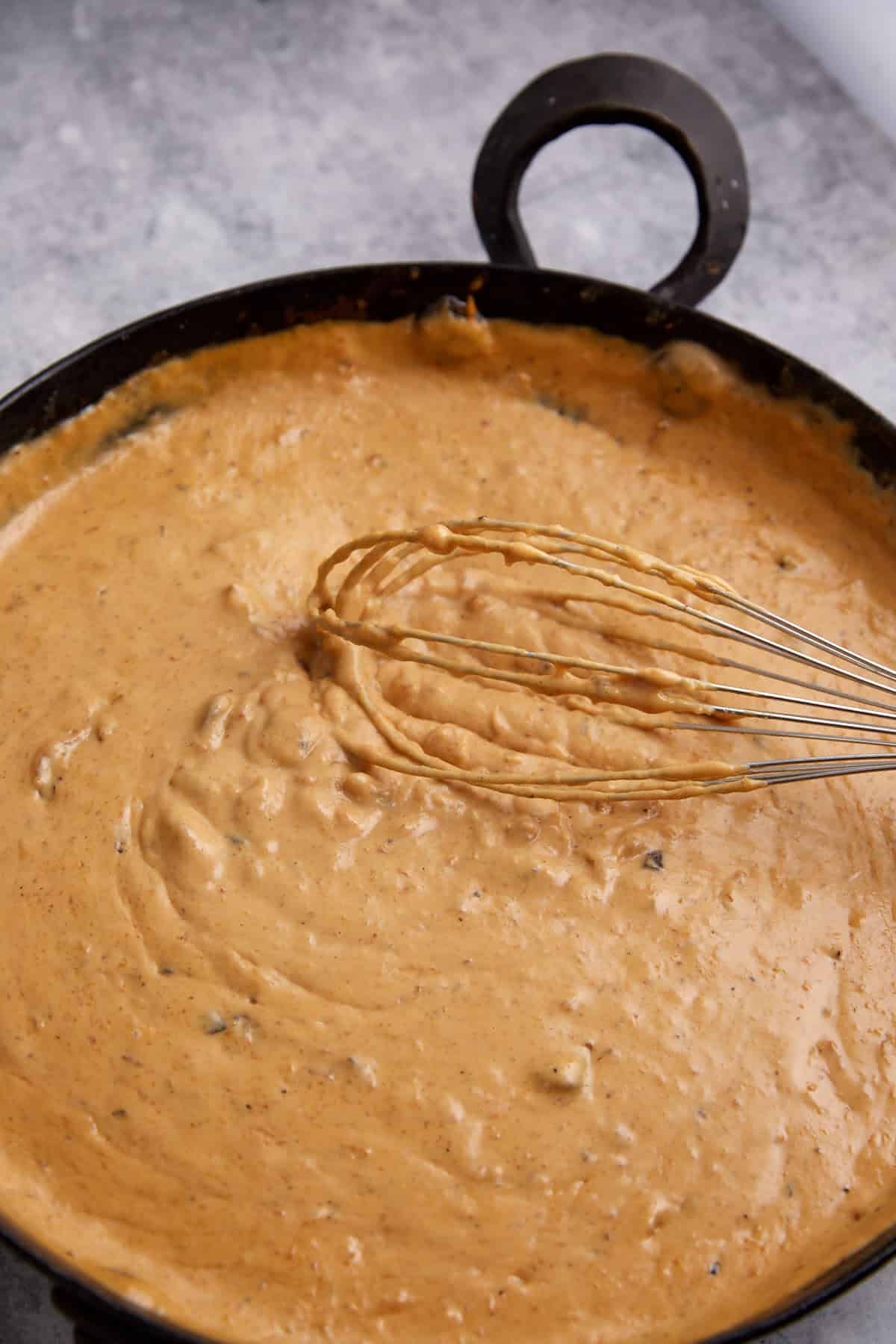 A skillet with the finished sauce.