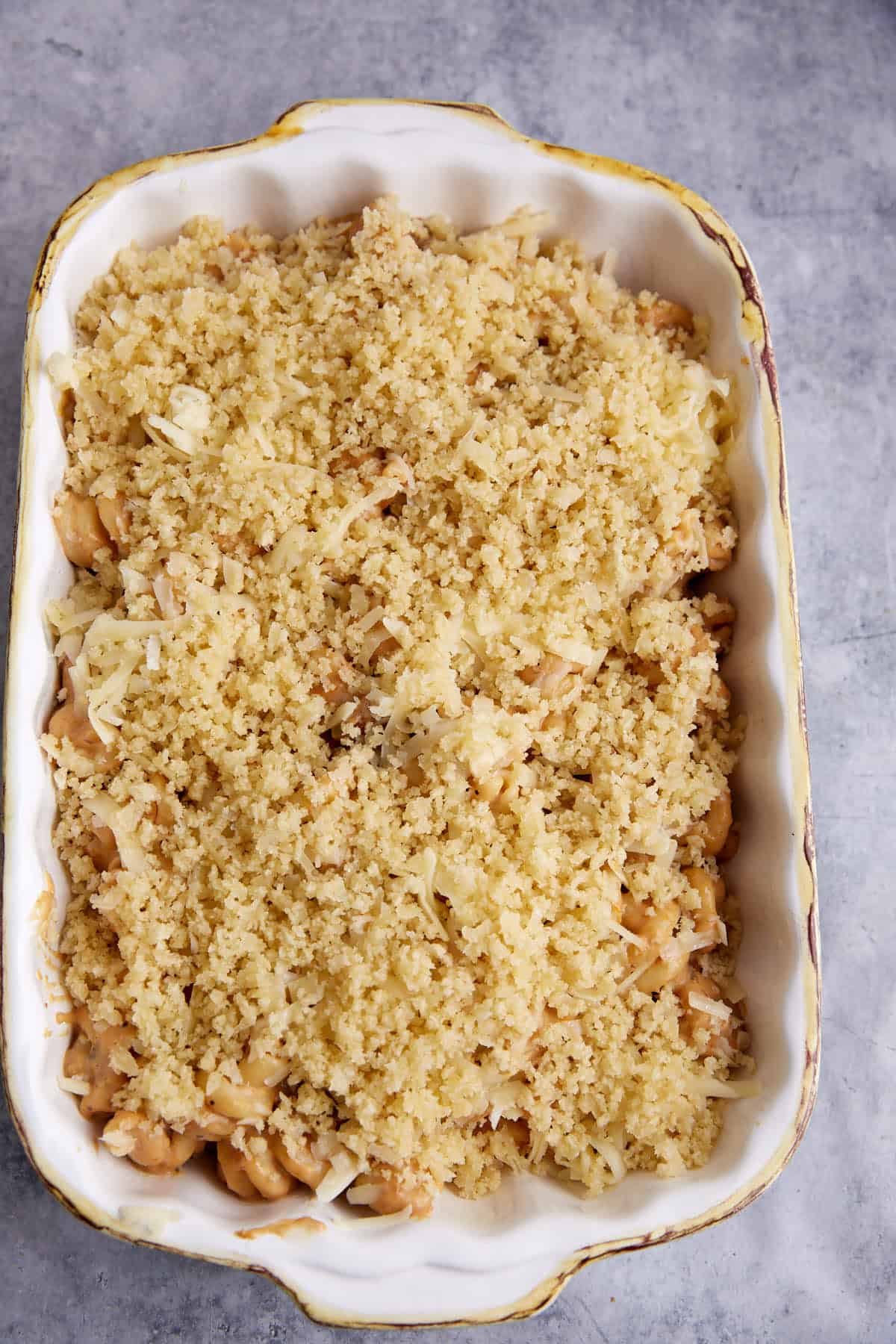 Cheese and panko added to the top of a butternut squash casserole.