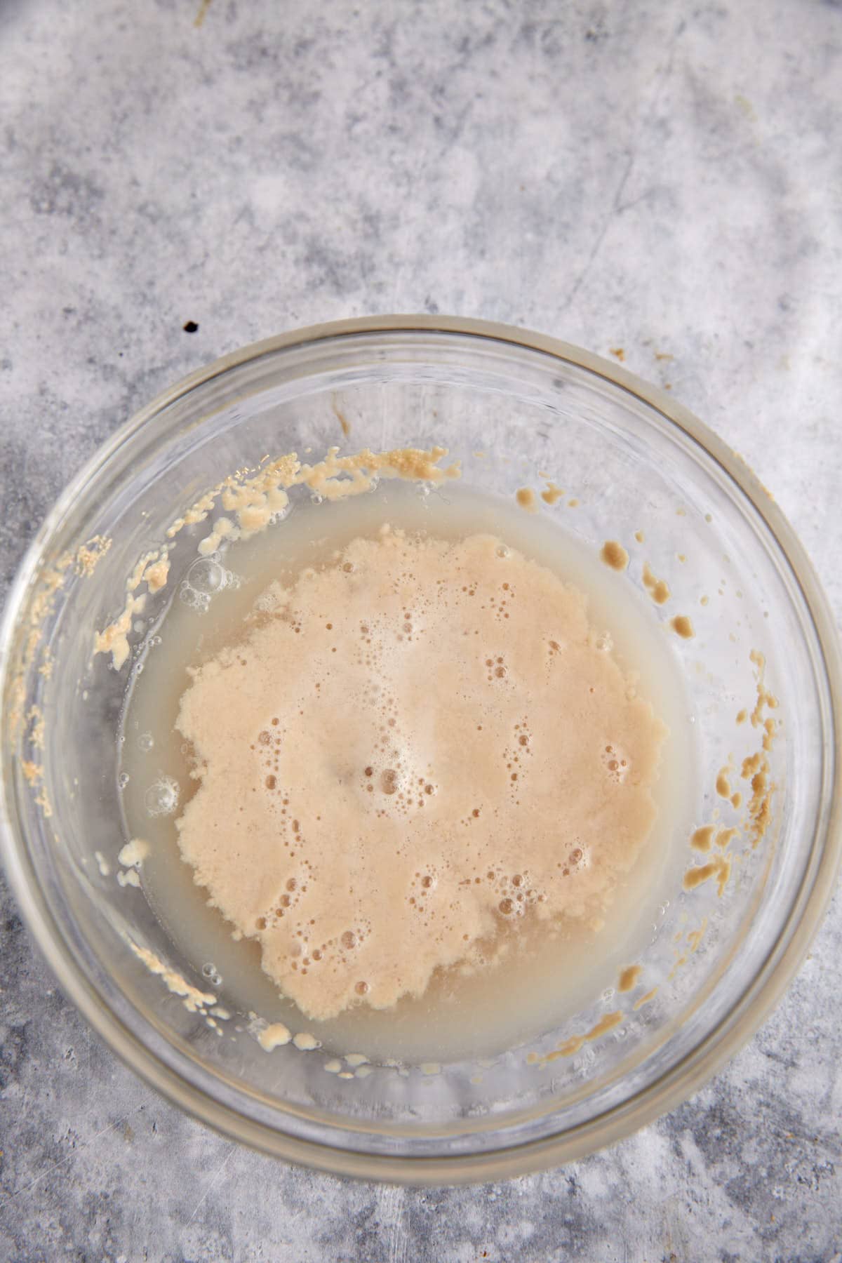 Yeast dissolving in a bowl of water.