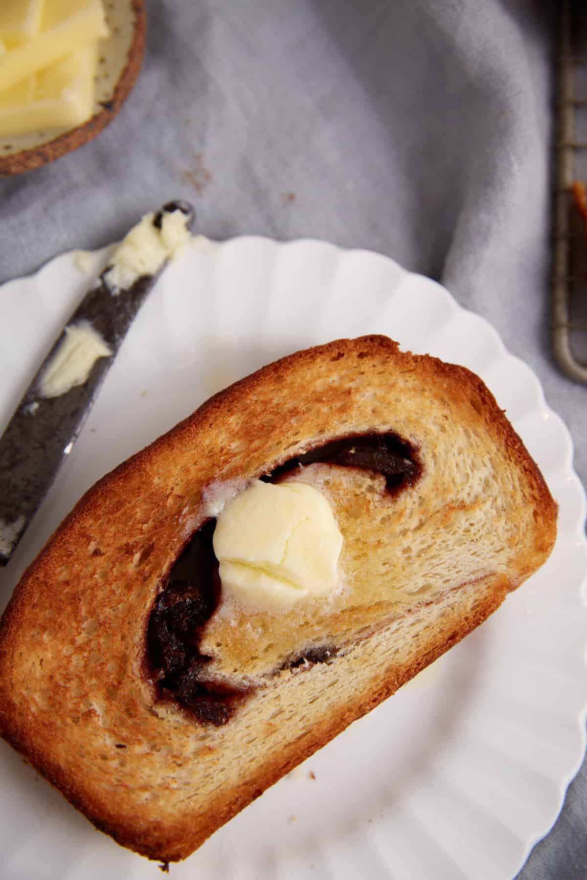 A slice of toasted cinnamon bread with butter.