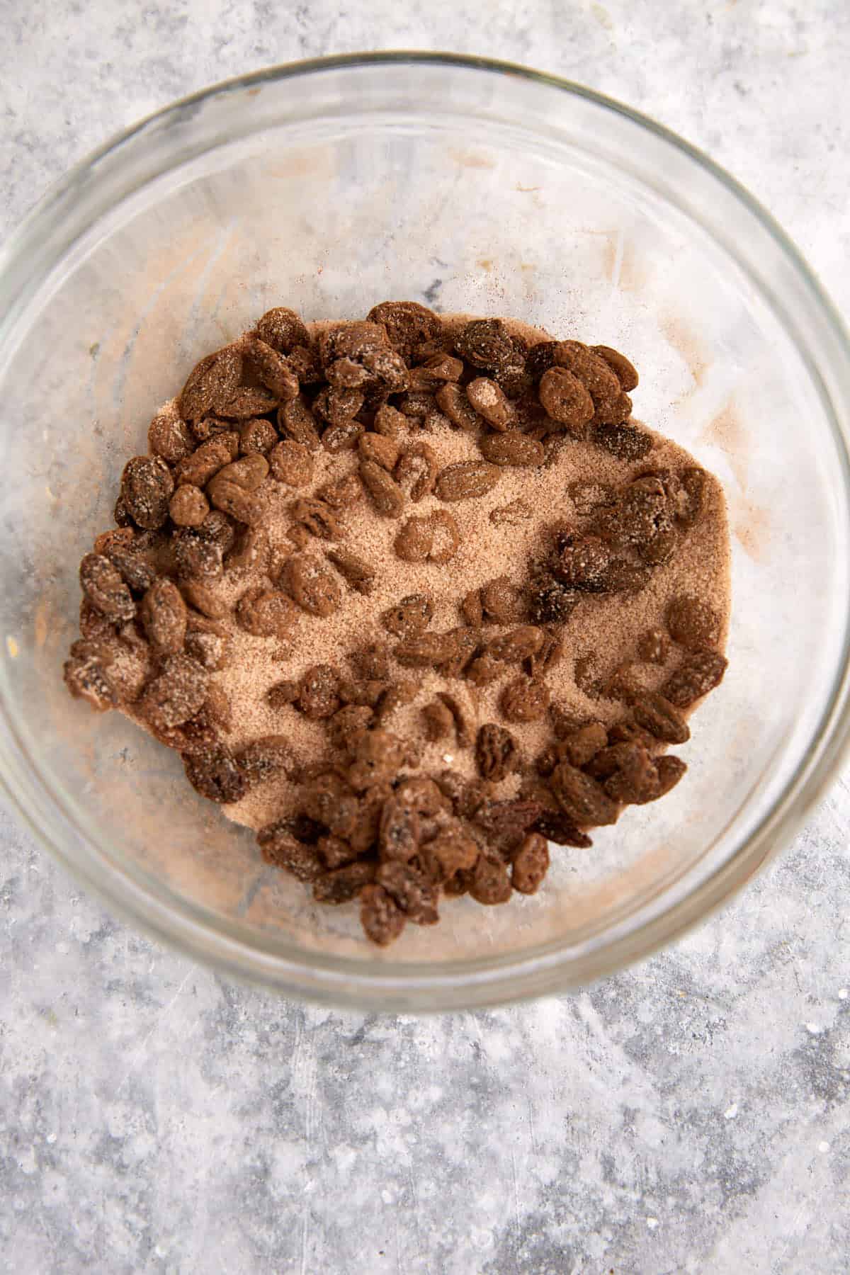 A bowl of cinnamon sugar mixture with raisins.