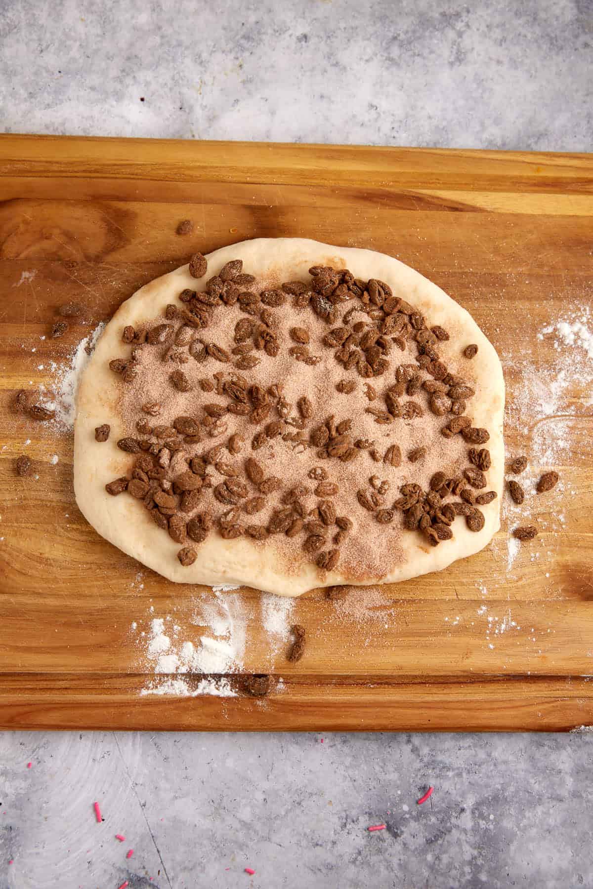 Raisins and a cinnamon sugar mixture spread on yeast dough.