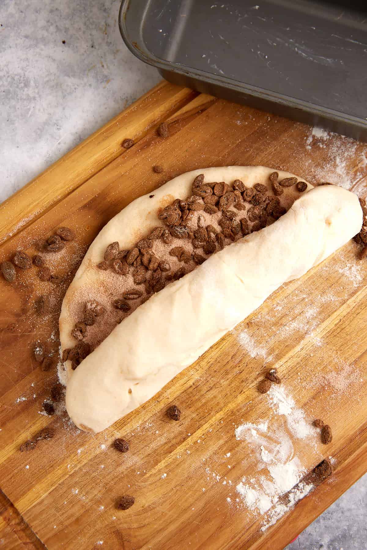The cinnamon raisin dough being rolled.